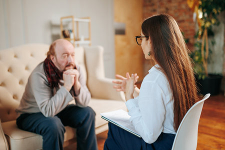 Blurred background selective focus unrecognizable session of a psychologist, psychological consultation with a client. Mental health, human resources specialist. psychotherapist in the field of aging.の写真素材