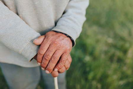 This close-up image offers a glimpse into the life of an elderly farmer through the of his weathered hands, each wrinkle and crease reflecting the trialsの写真素材