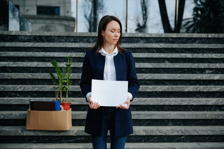 Yearning for a Job Woman in Distress Holding Need Banner on Stairsの写真素材