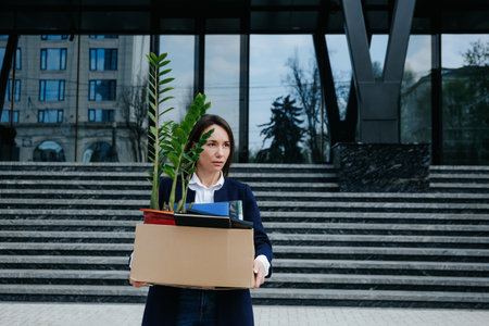 The Strain of Dismissal Depressed Woman Amidst Cardboardの写真素材
