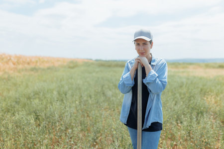 Rural Woman Taking a Break in a Sunlit Cornfield During a Busy Harvest Seasonの写真素材
