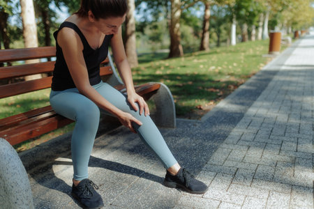 Young Brunette Woman Exercising and Training in the Park on a Beautiful, Sunny Dayの写真素材