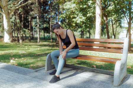 Brunette Young White Woman Performing Gymnastic Training Outside in the Parkの写真素材