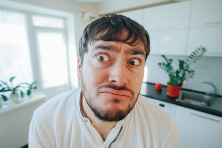 Close up of a bearded man with hilariously peculiar expressions,の写真素材