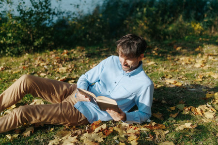 Outdoor Relaxation Man Reads on the Grass in Nature Calm