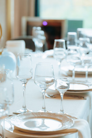 Elegant Table Setting with Crystal Glasses and White Plates for a Formal Eventの写真素材