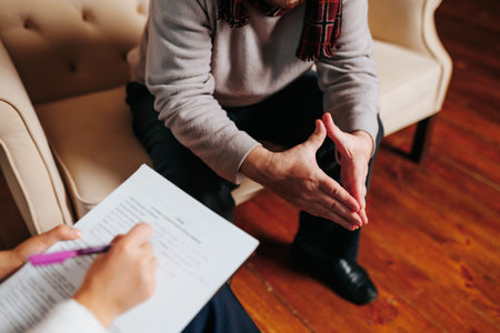 Counseling session with a focused discussion in a cozy room settingの写真素材