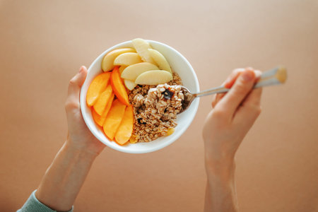 Healthy breakfast bowl with fresh fruit and oats served at home