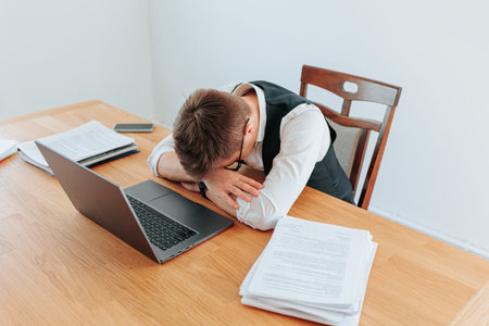 Young professional juggles workload while working from homeの写真素材
