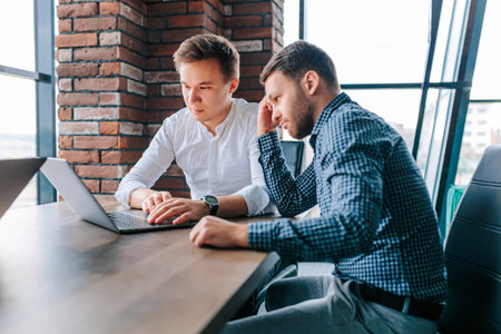 Colleagues collaborate on project with mentors guidance in modern office settingの写真素材