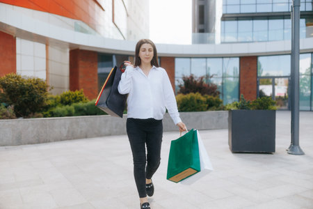 Young pregnant woman enjoys shopping at the urban plazaの写真素材