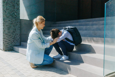 Mom Comforts Exhausted Son After School on Outdoor Steps