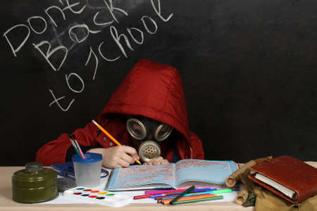 A child at a desk with a gas maskの写真素材