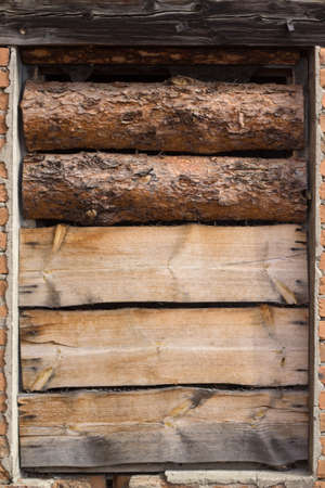 Window in the old brick house is full of boardsの写真素材