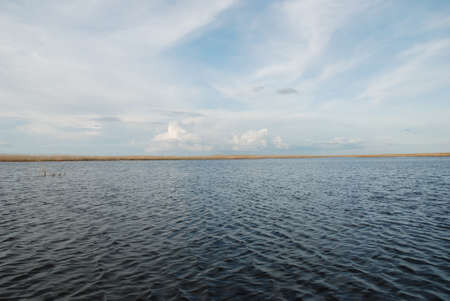 An unusual, beautiful evening over the lake. Light clouds obscured the sky.の写真素材