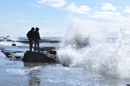 Sea waves breaking on concrete port の写真素材