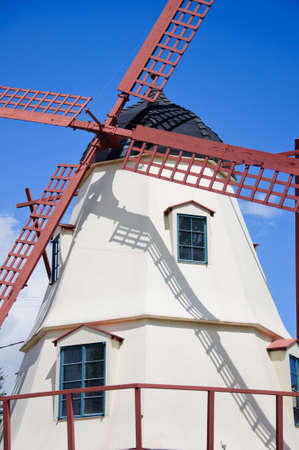 Old wind mill at the park with blue sky cloudsの写真素材