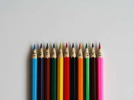 Color pensils with faces painted on them. The concept of an equality in the worldの写真素材
