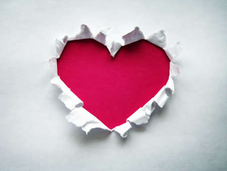 Torn paper in heart shape pink color.の写真素材