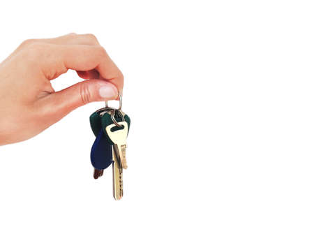 A bunch of keys in hand on a white background. Isolated.の写真素材