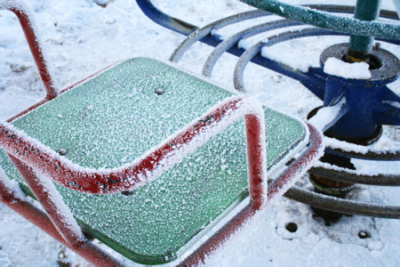 Frozen swings. Defocused backgroundの写真素材