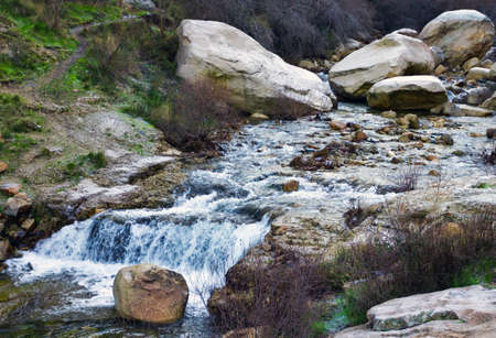 Three big stones with a waterfall of a small river in Spainの写真素材