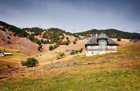 Old traditional house located on the top of the Carpathian Mountains. Romanian mountain villages.の写真素材