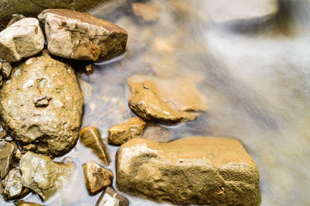 blurred water and stones backgroundの写真素材