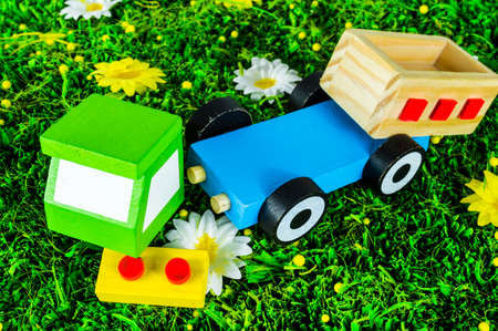 Crushed toy truck on a grass backgroundの写真素材