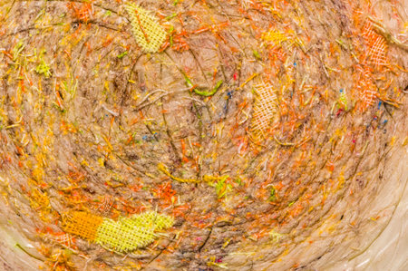 Colored pieces of cloth stuck in plastic 