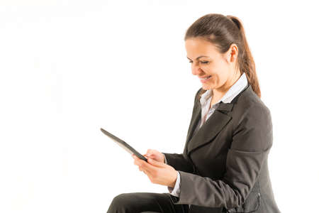 Clean modern portrait of a mature professional business woman with ample copy space. Isolated on white background. Woman using digital tablet, happy, isolated on white background.の写真素材