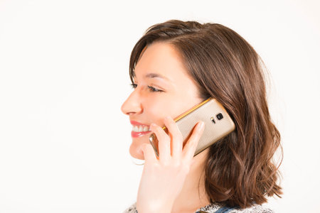 portrait of a happy young woman in casual clothes, speaking on cell phone. Connected anytime...
