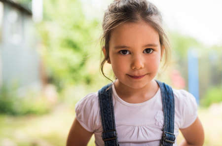 Outdoor portrait of a smiling little girlの写真素材
