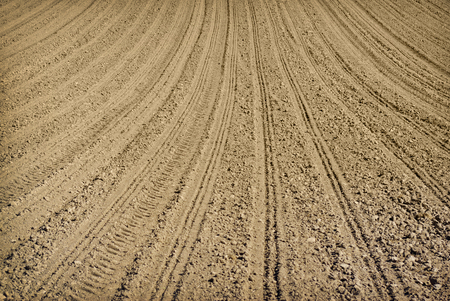 Plowed land on the field during agricultural workの写真素材