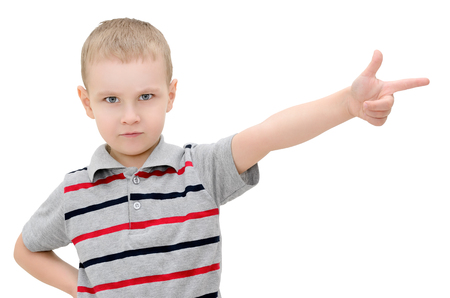 Angry little boy shows a finger on a white backgroundの写真素材