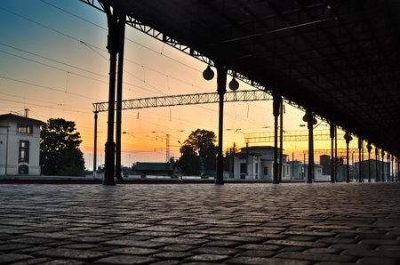 Pavement of paving stones at the railway station, at sunset. Transport infrastructure.の写真素材