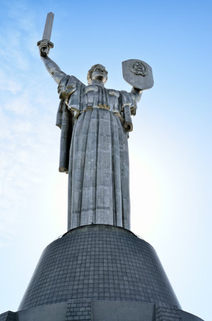 Monument Rodina Mother on the background of the blue sky. Communist symbol of the totalitarian Soviet regime in Kiev, Ukraine.のeditorial素材