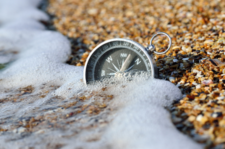 Nautical compass in the sand on the seashore. Marine navigation.の写真素材