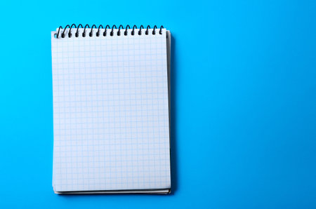 Notepad for notes is open on a blank page. Stationery, note paper.