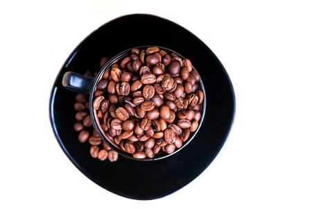 Coffee mug full of coffee beans isolated on white background.の写真素材