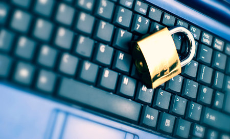 Laptop keyboard with locker and keys on top.