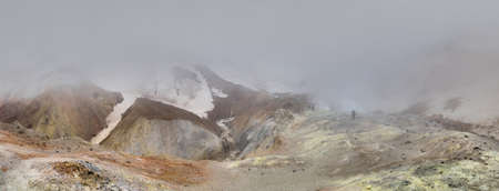 group of Mutnovsky volcanoes and tourists in the fog on the Kamchatka Peninsulaの写真素材