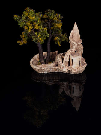 Bonsai miniature tree in a ceramic pot isolated on blackの写真素材