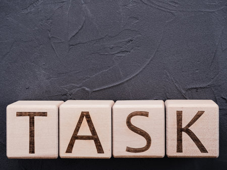Word TASK on wooden cubes on gray concrete backgroundの写真素材