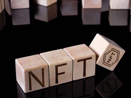 Text NFT on wooden cubes as concept of non-fungible tokens tradingの写真素材
