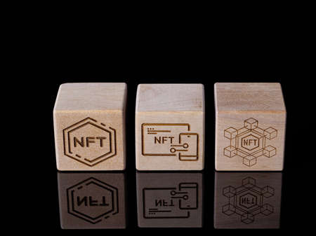 Symbols NFT on wood blocks as concept of using non-fungible tokensの写真素材