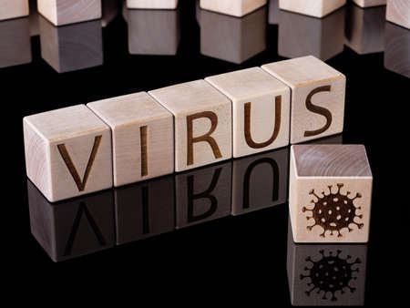 VIRUS text on wooden blocks as a pandemic or covid-19 endemic conceptの写真素材
