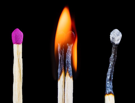 A whole, burning and burned match as a concept of everything passingの写真素材