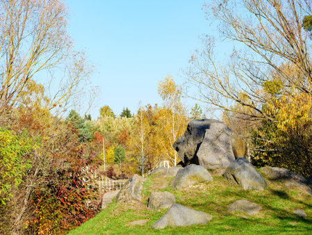 A hillock covered with green grass with large bouldersの写真素材
