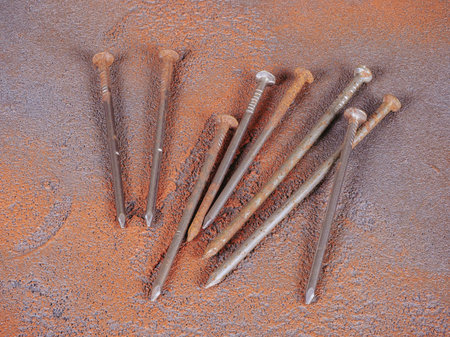 Bunch of old rusty nails on a grunge style backgroundの写真素材
